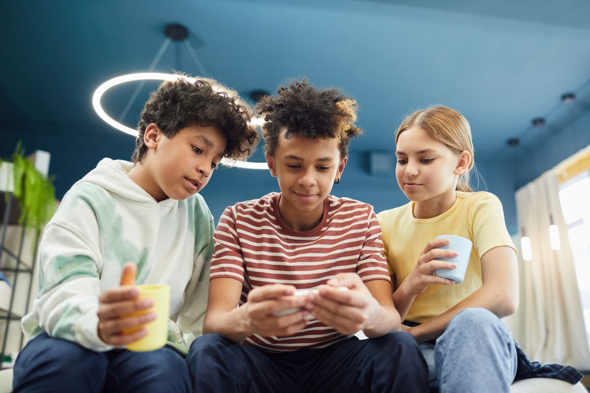 A diverse group of friends earning rewards together on their phones
